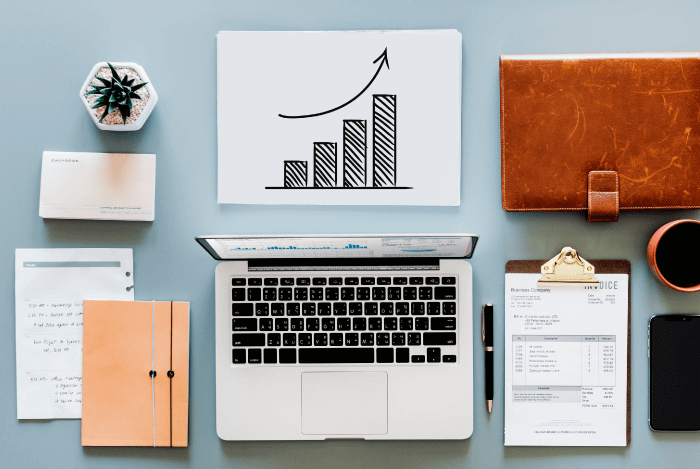 sentiment analysis - a table with multiple objects including a notebook, flower, graph, chart, infographic, coffee, glasses, phone